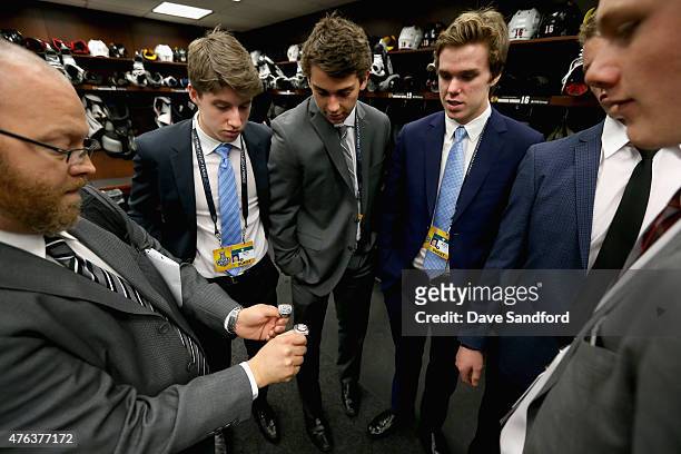 Senior Director of Team Services for the Chicago Blackhawks Tony Ommen shows the NHL top draft prospects Noah Hanafin, Jack Eichel, Connor McBride,...