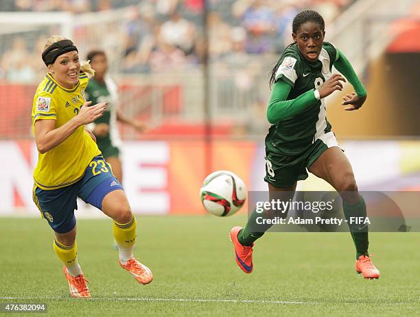 Elin Rubensson of Sweden chase down the ball with Asisat Oshoala of Nigeria during the FIFA Women's World Cup Canada 2015 Group D match between...