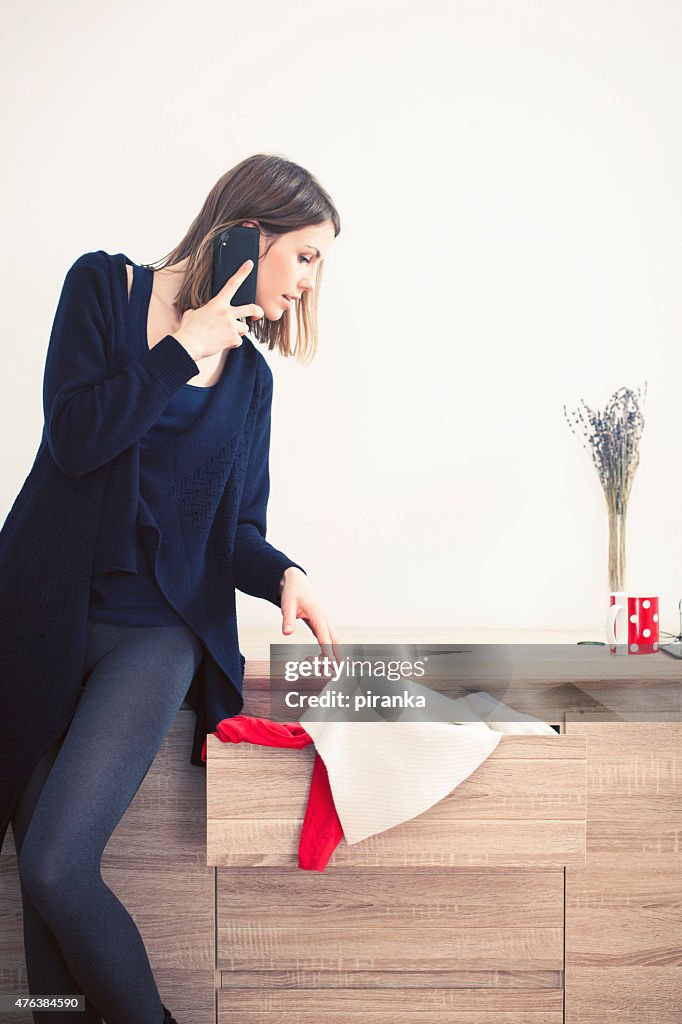 Woman on the phone choosing what to wear