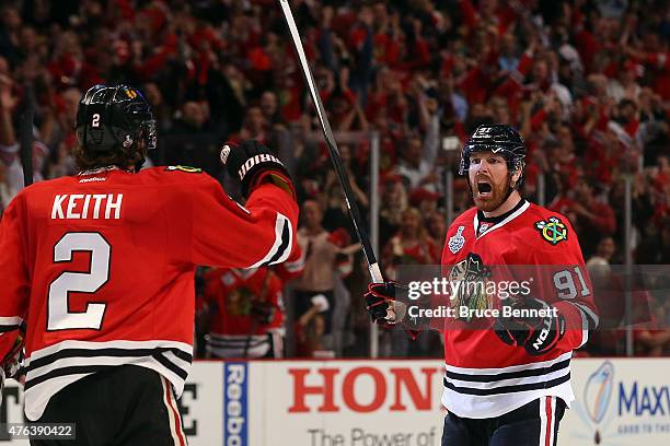 Brad Richards of the Chicago Blackhawks celebrates a first period goal with Duncan Keith against the Tampa Bay Lightning during Game Three of the...