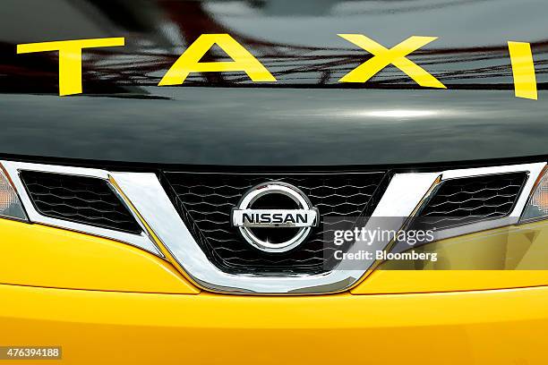 The Nissan Motor Co. Badge is displayed on the company's NV200 Taxi cab for Sanshin Kotsu Co. During a launch event in Tokyo, Japan, on Monday, June...