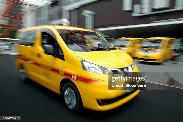 Nissan Motor Co. NV200 Taxi cab for Daiwa Motor Transportation Co. Drives through a parking lot during a launch event in Tokyo, Japan, on Monday,...