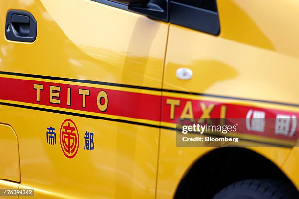 Nissan Motor Co. NV200 Taxi cab for Teito Jidosha Kotsu Co. Sits in a parking lot during a launch event in Tokyo, Japan, on Monday, June 8, 2015....