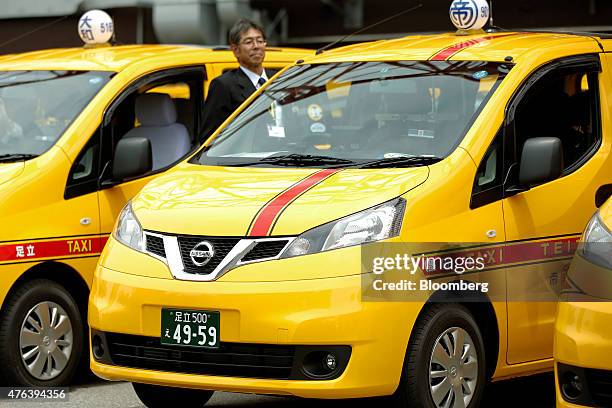 Nissan Motor Co. NV200 Taxi cab for Teito Jidosha Kotsu Co., center, sits in a parking lot during a launch event in Tokyo, Japan, on Monday, June 8,...