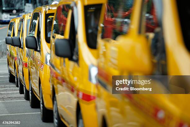 Nissan Motor Co. NV200 Taxi cabs for various taxi companies sit in a parking lot during a launch event in Tokyo, Japan, on Monday, June 8, 2015....