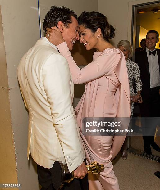 Matthew McConaughey and Camila Alves kiss backstage during the Oscars held at Dolby Theatre on March 2, 2014 in Hollywood, California.