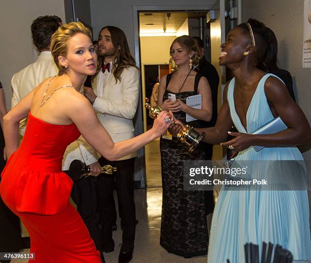 Actresses Jennifer Lawrence and Lupita Nyong'o backstage during the Oscars held at Dolby Theatre on March 2, 2014 in Hollywood, California.