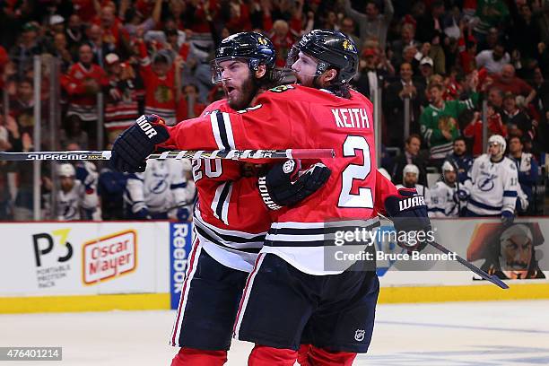 Brandon Saad celebrates a third period goal with Duncan Keith of the Chicago Blackhawks against the Tampa Bay Lightning during Game Three of the 2015...