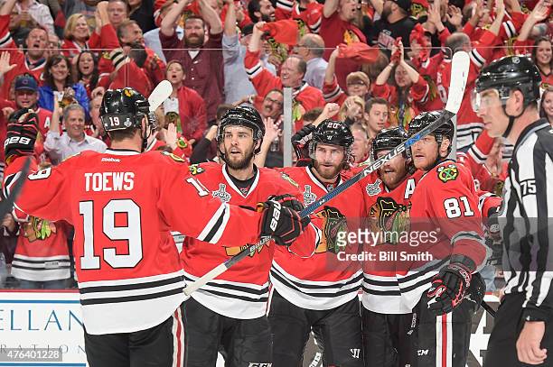 Brandon Saad of the Chicago Blackhawks celebrates with Niklas Hjalmarsson, Duncan Keith and Marian Hossa after scoring against the Tampa Bay...