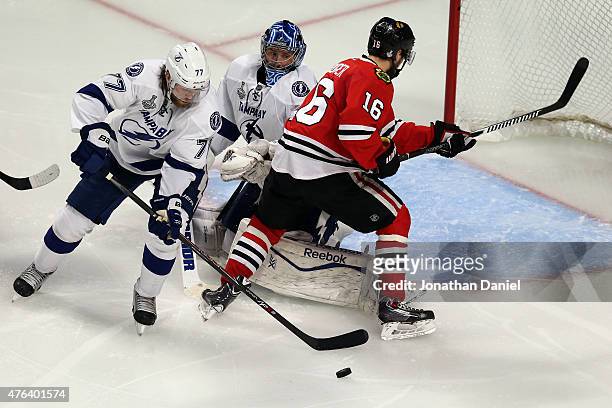 Ben Bishop and Victor Hedman of the Tampa Bay Lightning defend against Marcus Kruger of the Chicago Blackhawks during Game Three of the 2015 NHL...