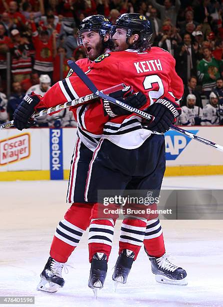 Brandon Saad celebrates a third period goal with Duncan Keith of the Chicago Blackhawks against the Tampa Bay Lightning during Game Three of the 2015...