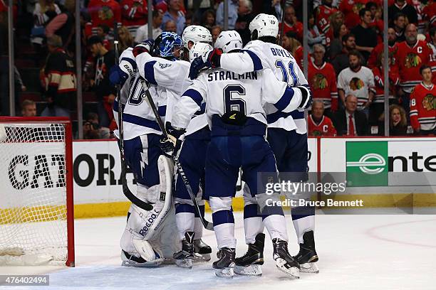 Ben Bishop of the Tampa Bay Lightning celebrates with his teammates after defeating the Chicago Blackhawks 3-2 in Game Three of the 2015 NHL Stanley...