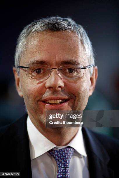 Michel Combes, chief executive officer of Alcatel-Lucent SA, poses for a photograph on the opening day of the Mobile World Congress in Barcelona,...