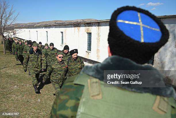 Unit claiming to Cossack and other citizen pro-Russian volunteers arrive to take up position outside a Ukrainian miltary base where heavliy-armed...