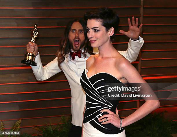 Actor Jared Leto photobombs actress Anne Hathaway at the 2014 Vanity Fair Oscar Party hosted by Graydon Carter on March 2, 2014 in West Hollywood,...