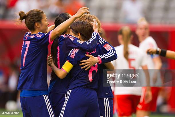 Aya Miyama of Japan is congratulated by teammates Yuki Ogimi and Mizuho Sakaguchi after scoring on a penalty shot against Switzerland during the FIFA...