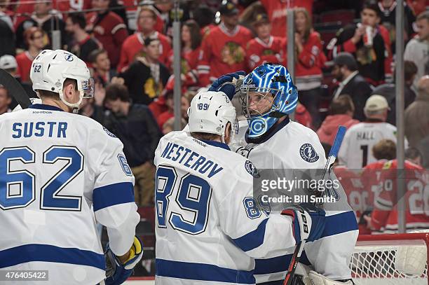Goalie Ben Bishop of the Tampa Bay Lightning celebrates with teammates after defeating the Chicago Blackhawks 3-2 during Game Three of the 2015 NHL...