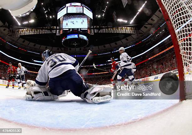 Goaltender Ben Bishop of the Tampa Bay Lightning lets in the puck on a shot by Brandon Saad of the Chicago Blackhawks during the third period of Game...