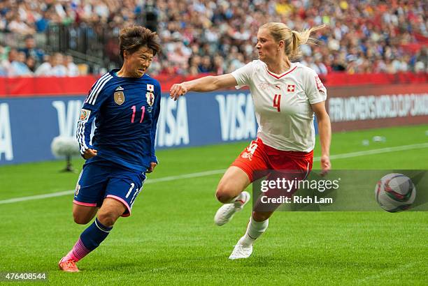 Shinobu Ohno of Japan tries to get past Rachel Rinast of Switzerland during the FIFA Women's World Cup Canada 2015 Group C match between Japan and...