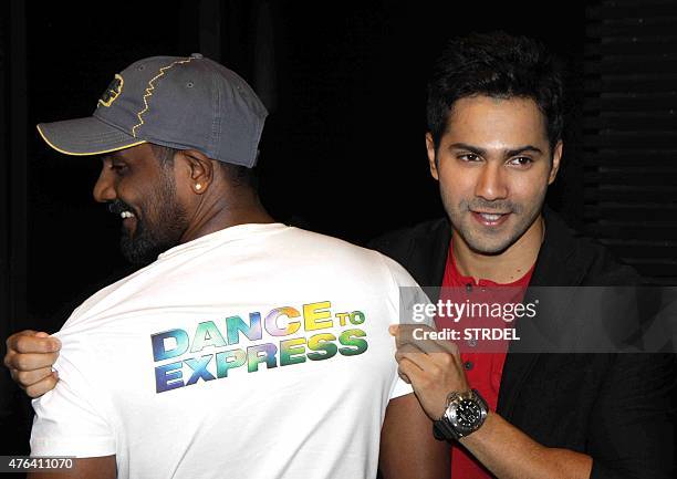 Indian Bollywood actor Varun Dhawan poses with director Remo D'Souza during the launch of a song for the forthcoming Hindi film ABCD 2 in Mumbai late...
