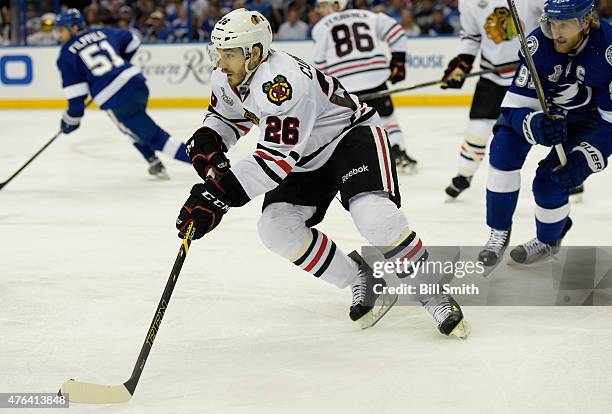 Kyle Cumiskey of the Chicago Blackhawks is chased by Steven Stamkos of the Tampa Bay Lightning during the first period of Game One of the 2015 NHL...