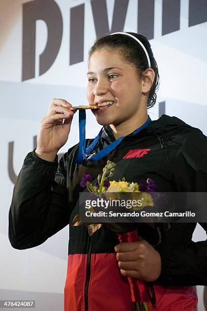 Dolorez Hernández from M�éxico bites her gold medal after winning in the 3 meter springboard during the Day 2 of a diving qualifier for the Youth...