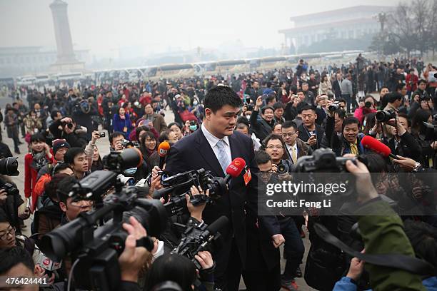 Yao Ming, a former NBA basketball star and a delegate to the Chinese People's Political Consultative Conference, is surrounded by media outside the...
