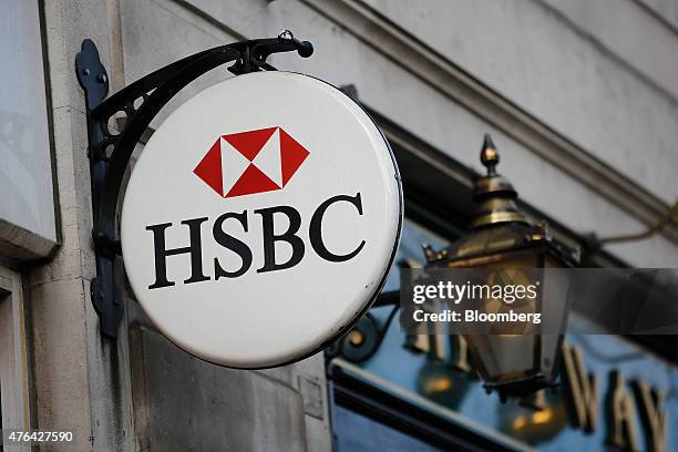 An HSBC logo sits on display outside an HSBC Holdings Plc bank branch in London, U.K., on Tuesday, June 9, 2015. HSBC will eliminate as many as...