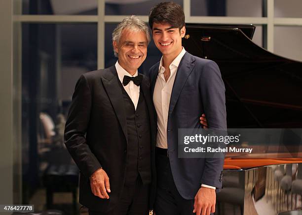 Andrea Bocelli and son Matteo Bocelli break away from the guests for a moment together at the piano during Alfred Mann Foundation's an Evening Under...