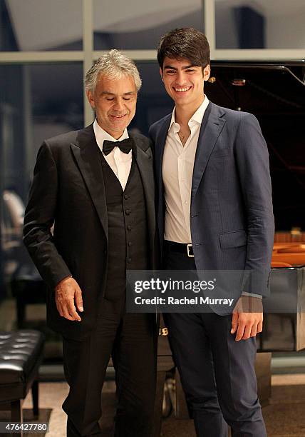 Andrea Bocelli and son Matteo Bocelli break away from the guests for a moment together at the piano during Alfred Mann Foundation's an Evening Under...