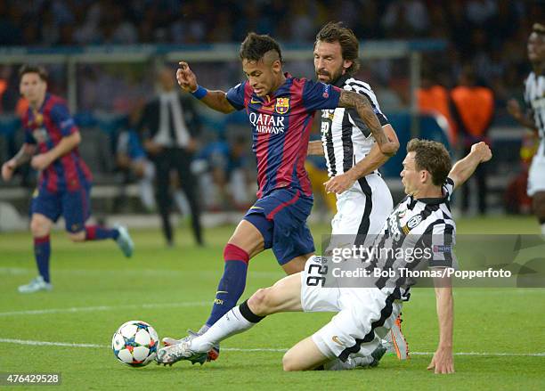 June 06: Neymar of Barcelona is tackled by Stephan Lichtsteiner of Juventus during the UEFA Champions League Final between Juventus and FC Barcelona...