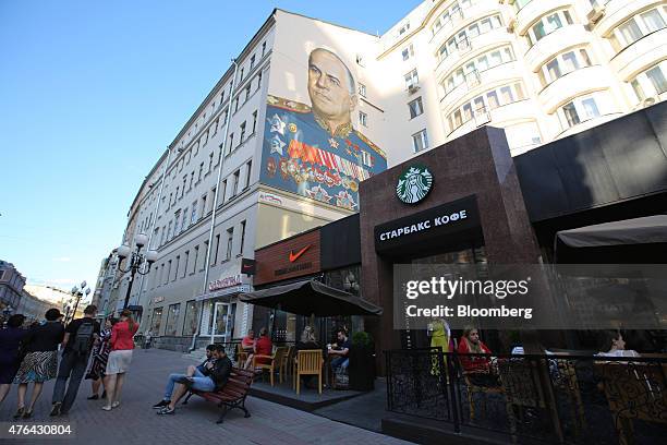 Wall mural, depicting Russian General Georgy Zhukov, a World War II Soviet hero, sits on a building above a Nike Inc. Sportswear store and a...