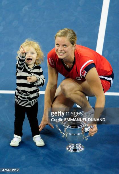 Tennis player Kim Clijsters from Belgium is joined by her daughter Jada after winnings against Caroline Wozniacki from Denmark during the Women's...