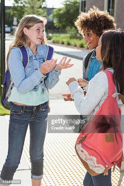 students talking outside school - ten to fifteen stock pictures, royalty-free photos & images