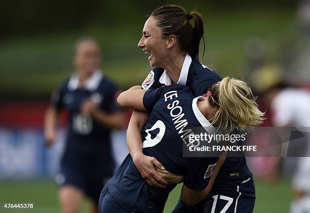 France's forward Eugenie Le Sommer is congratuled by France's forward Gaetane Thiney after scoring a goal during a Group F match at the 2015 FIFA...