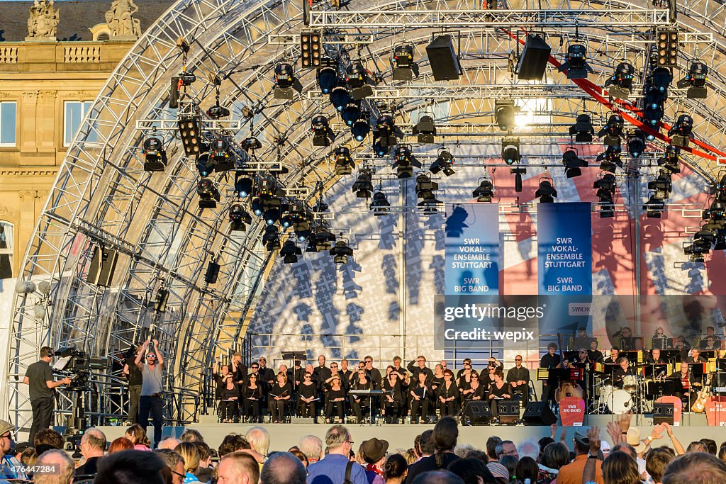 Music performance orchestra outdoor stage musicians tv-camera audience