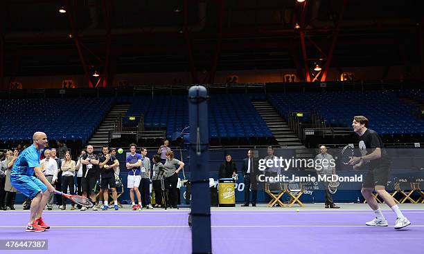 Andre Agassi plays tennis with Johnathan Ross during a tennis clinic during the World Tennis Day London Showdown press conference at the Athenaeum...