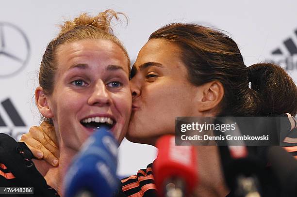 Dzsenifer Maroszan of Germany gives her team mate Simone Laudehr a peck on the cheek as she is asked about her opinion about Dzsenifer Maroszan...