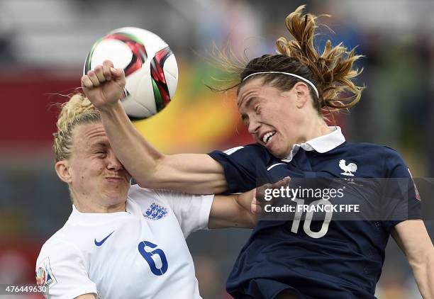 England's defender Laura Bassett vies with France's midfielder Camille Abily during a Group F match at the 2015 FIFA Women's World Cup between France...