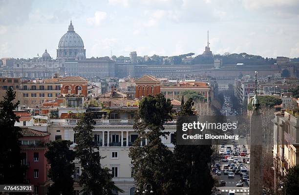 The dome of St. Peter's Basilica stands on the horizon as automobiles pass along a road in Rome, Italy, on Monday, March 3, 2014. Italian Prime...