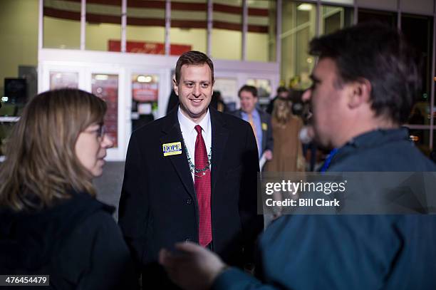 Virginia state delegate Patrick Hope greets arriving attendees during the Mount Vernon District Democratic Committee's annual Mardi Gras fundraiser...