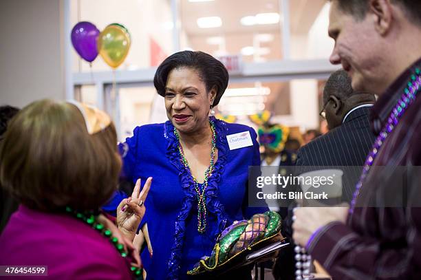 Lavern Chatman speaks with attendees during the Mount Vernon District Democratic Committee's annual Mardi Gras fundraiser at Don Beyer's Volvo car...