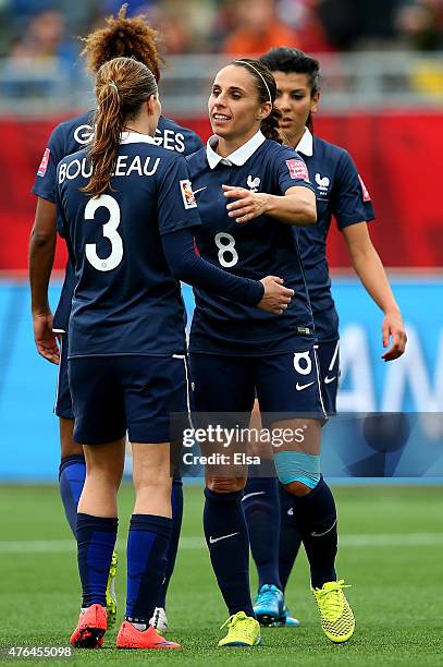 Laure Boulleau and Jessica Houara of France celebrate the win over England during the FIFA Women's World Cup 2015 Group F match at Moncton Stadium on...