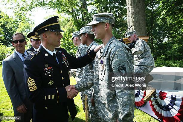 Sergeant Major of the Army of the U.S. Army Daniel Dailey greets recipient Specialist Spencer Jacobsen of the Bravo Troop, 1st Squadron, 33rd Calvary...