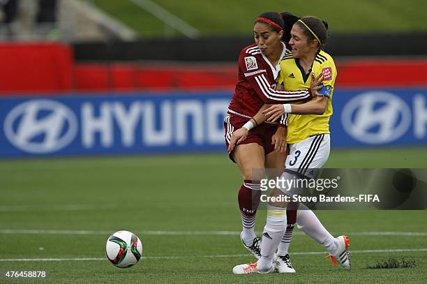 Natalia Gaitan of Colombia challenges for the ball with Renae Cuellar of Mexico during the FIFA Women's World Cup 2015 Group F match between Colombia...