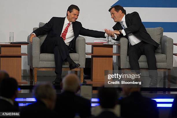 Enrique Pena Nieto, Mexico's president, left, speaks with Vicente Rodero, chief executive officer of BBVA Bancomer, during the BBVA Bancomer national...