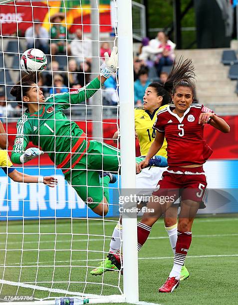 Stefany Castano of Colombia is unable to stop a shot by Veronica Perez of Mexico as Valeria Miranda of Mexico stands by during the FIFA Women's World...