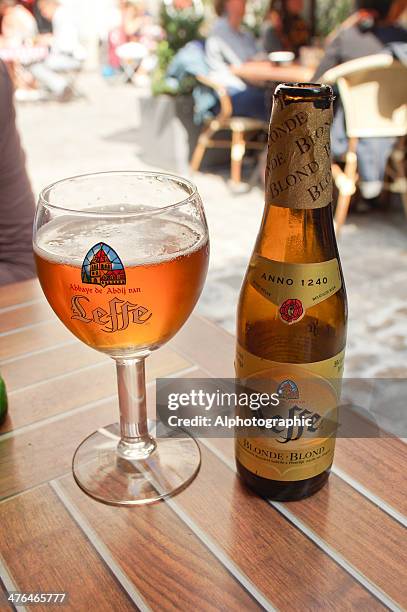 leffe beer bottle and glass - lille cafe stock pictures, royalty-free photos & images