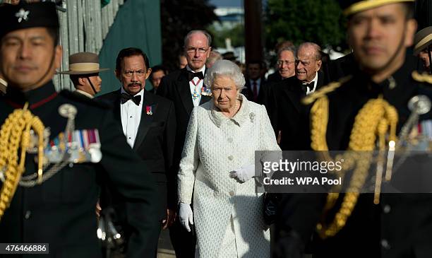 Queen Elizabeth II with the Sultan of Brunei arrive at the Gurkha 200 pageant in the grounds of the Royal Hospital Chelsea on June 9, 2015 in London,...