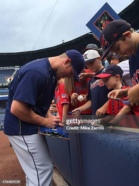 Pitcher Craig Kimbrel of the San Diego Padres, and formerly of the Atlanta Braves, signs autographs for fans before the game against the Atlanta...